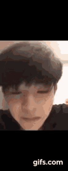 a close up of a young man with his eyes closed .