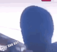 a blurry picture of a person 's head with the words waiz dah boy below it