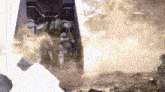 a helicopter is flying through a cloud of dust in the sky .