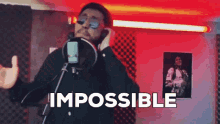a man is singing into a microphone with the word impossible written on the bottom