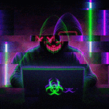 a person in a hoodie with a neon mask on their face is using a laptop