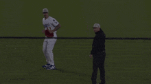 a baseball player wearing a white jersey with the number 4 on it