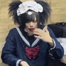 a person in a maid costume is talking on a cell phone