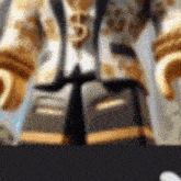 a close up of a lego figure wearing a gold suit and tie .