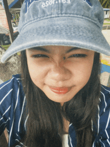 a girl wearing a blue hat that says ' a.s.a.r. ' on it