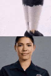 a woman in a police uniform is smiling in front of a woman in stockings