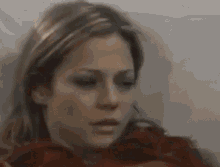 a woman is laying in a hospital bed and looking at the camera