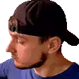 a man with a beard is wearing a baseball cap .