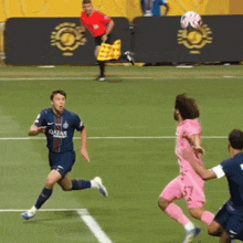 a soccer player wearing a qatar jersey runs towards a defender