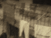 a blurry picture of a person standing in a room