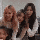 a group of young women are standing next to each other in a room and smiling .