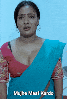 a woman in a blue saree with the words mujhe maaf kardo written below her