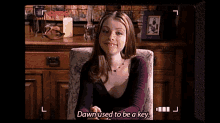 a woman sitting in a chair with the words dawn used to be a key on the screen