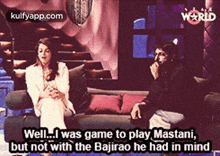 a man and a woman are sitting on a couch with a caption that says well i was game to play mastani