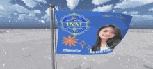 a blue flag with a picture of a girl and the word tnaf