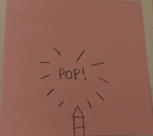 a pink piece of paper with a drawing of a rocket and the word pop written on it