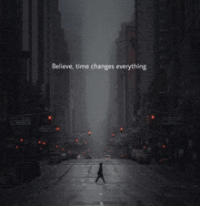 a person walking down a city street with the words " believe time changes everything " above them