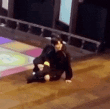 a person is sitting on the floor in a room with a colorful floor .