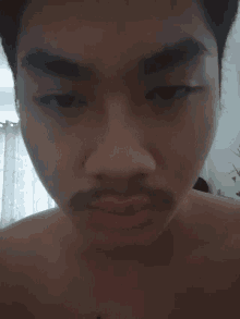a close up of a man 's face without a shirt