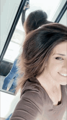 a woman taking a picture of herself in front of a mirror