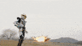 a man in a superhero costume is standing in front of a large explosion