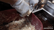 a person is mixing food in a red container that says made in animatica