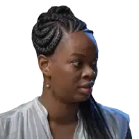 a woman with braids and earrings looks to her left