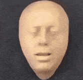 a close up of a mannequin head with its mouth open .