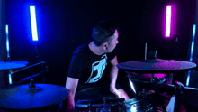 a man wearing a black shirt with the letter j on it