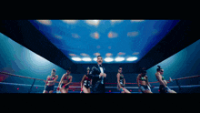 a man in a tuxedo is in a boxing ring