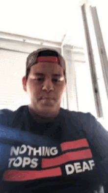 a man wearing a t-shirt that says " nothing tops deaf "