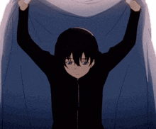 a boy in a black jacket is holding up a white cloth