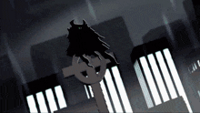 a silhouette of a person standing on a cross in front of buildings