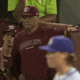 a man wearing a maroon shirt that says carolina