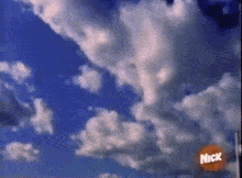 a blue sky with clouds and a nick logo