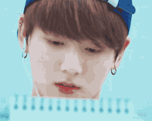 a close up of a person 's face with a blue hat on