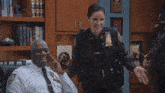 two police officers are laughing and one has a patch on her uniform that says ' brooklyn ' on it