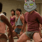 a man with a cat mask on his head is dancing