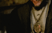 a man with curly hair and a beard is smiling and laughing .