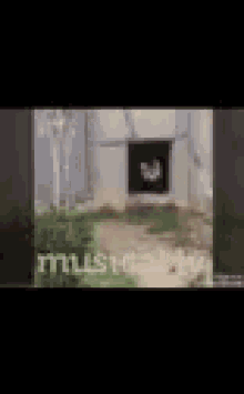 a blurred image of a person standing in front of a fence .