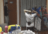 a woman adjusts her hair in a room with a sign that says ' dressing room '