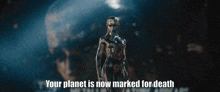 a statue with the words " your planet is now marked for death " written below it