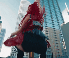 a woman with red hair is wearing a jersey that says ' denver ' on it