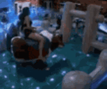a blurry picture of a group of people sitting on a carousel .