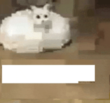 a pixelated image of a white cat sitting on top of a cake .