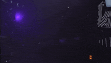 a dark room with a purple light coming out of the ceiling