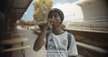 a man wearing an emirates jersey laughs