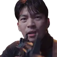 a close up of a man holding a gun