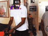 a man in a white shirt has a pixelated face with the letter cc on it