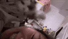 a cat is laying on a person 's head in a bedroom .